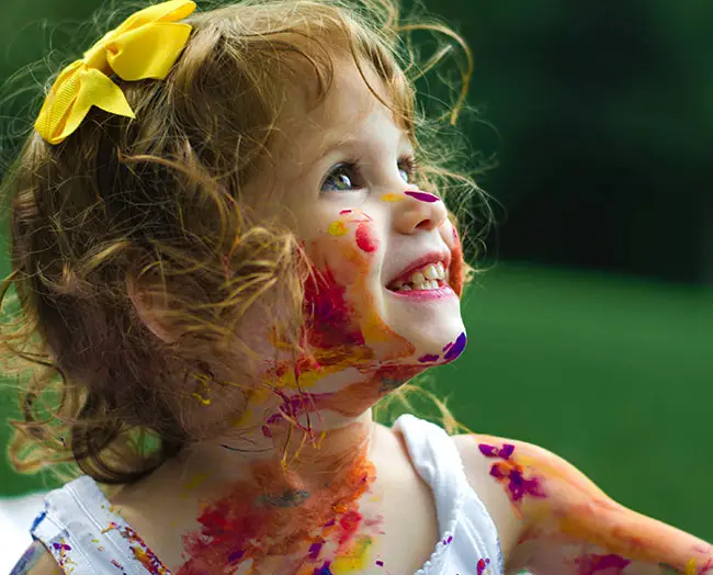 bambina con colori a tempera sulla faccia